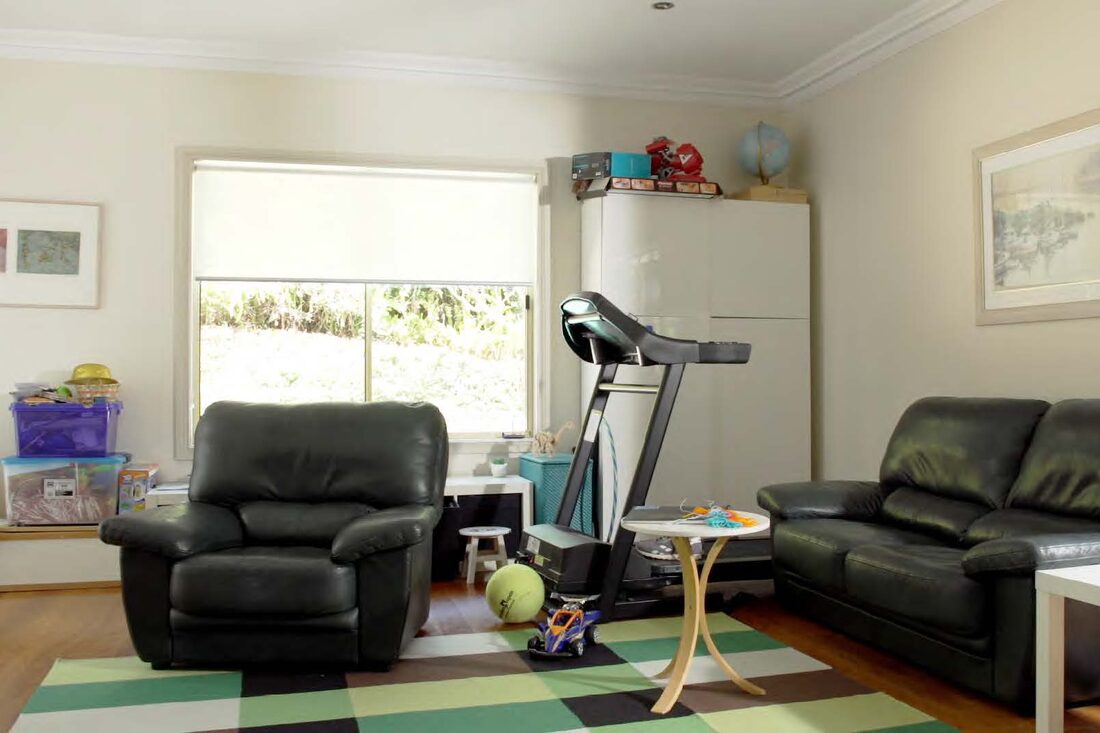 The Bluett living room before — clutter, no defined storage